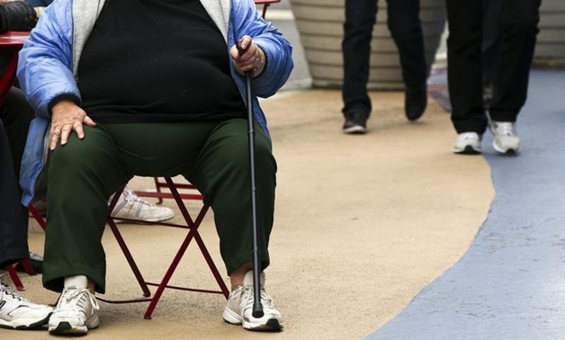 An overweight woman sits on a chair in Times Square in New York, May 8, 2012. REUTERS/Lucas Jackson