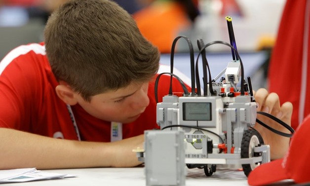 A participant from Canada prepares his miniature robot during the World Robot Olympiad at a convention center in San Rafael de Alajuela, Costa Rica November 10, 2017. — Reuters pic