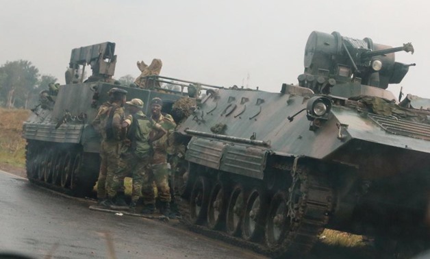 Soldiers stand beside military vehicles just outside Harare,Zimbabwe,November 14,2017. REUTERS/Philimon Bulawayo