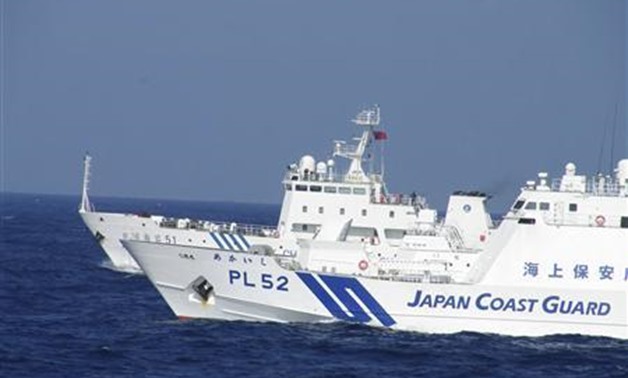 Chinese marine surveillance ship Haijian No. 51 (rear) cruises next to a Japan Coast Guard patrol ship, Akaishi, in the East China Sea near the disputed isles known as Senkaku isles in Japan and Diaoyu islands in China - REUTERS