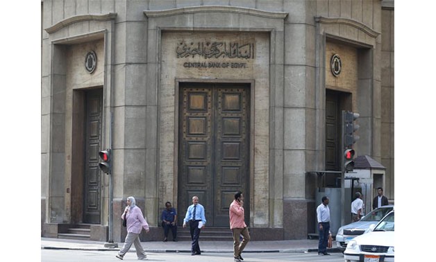 People walk in front of the Central Bank of Egypt's headquarters at downtown Cairo, Egypt - Reuters