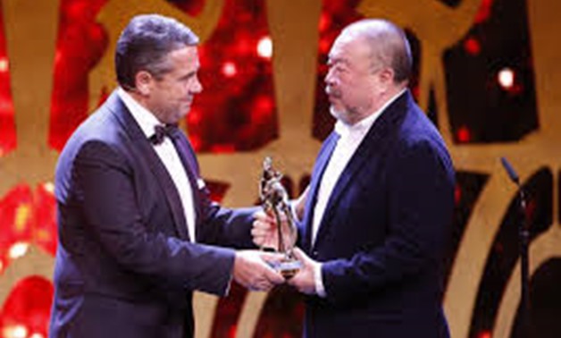 Artist Ai Weiwei receives the Bambi trophy from politican SIgmar Gabriel during the Bambi 2017 Awards ceremony in Berlin, Germany November 16, 2017 - REUTERS


