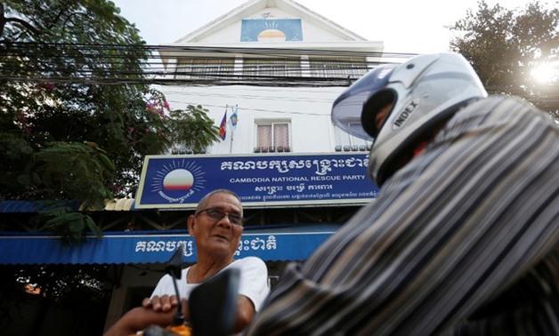 Men stand in front of the Cambodia National Rescue Party (CNRP) headquarters in Phnom Penh, Cambodia, November 17, 2017. REUTERS/Samrang Pring

