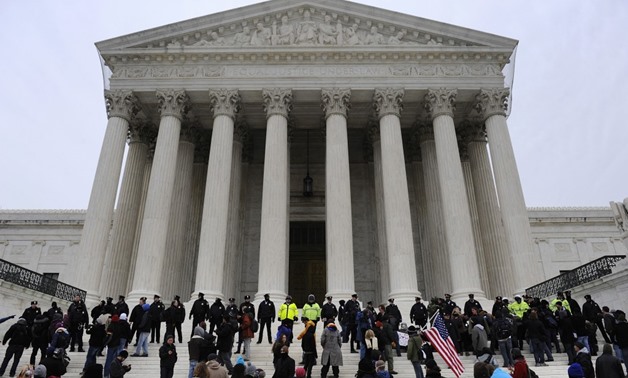 Police form a line after arresting demonstrators on the steps of the U.S. Supreme Court, on the anniversary of the Citizens United decision, in Washington, January 20, 2012. REUTERS/Jonathan Ernst