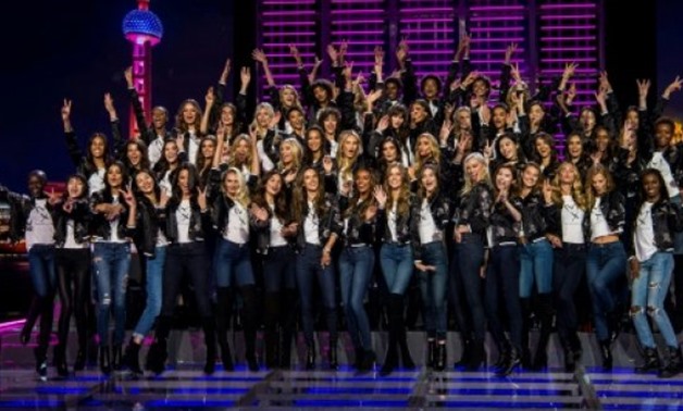 © AFP / by Dan Martin | Victoria's Secret models pose to mark the countdown to the 2017 fashion show in Shanghai