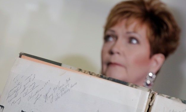 Accuser Beverly Young Nelson, who claimed that Alabama senate candidate Roy Moore sexually harassed her when she was 16, sits behind a signature by Roy Moore in her 1977 yearbook in New York - REUTERS

