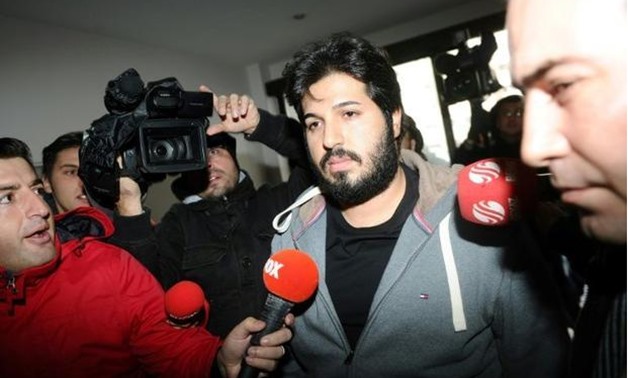Businessman Reza Zarrab (C) arrives at a police center in Istanbul in 2013 - AFP