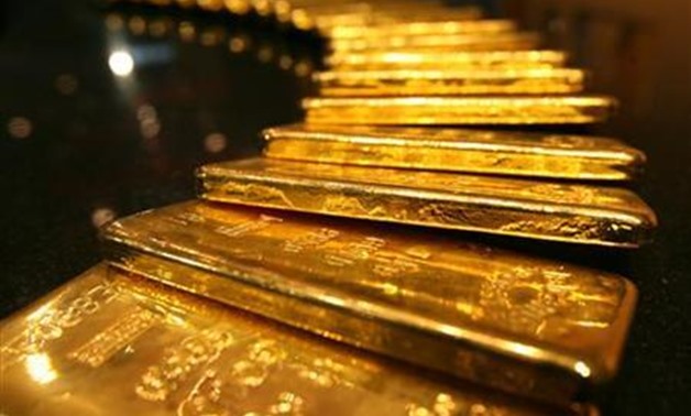 REUTERS- A gold kilo bars are displayed inside a secured vault in Dubai