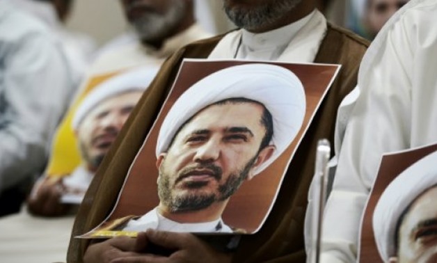 © AFP | A Bahraini man holds a portrait of jailed opposition leader Sheikh Ali Salman during a protest on May 29, 2016