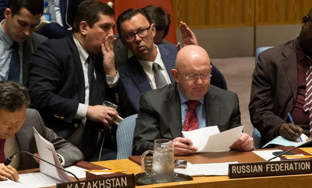 Russian diplomats gesture behind Russian Ambassador to the United Nations Vassily Nebenzia during a Security Council meeting on North Korea at the U.N. headquarters in New York City, U.S., September 4, 2017. REUTERS/Joe Penney
