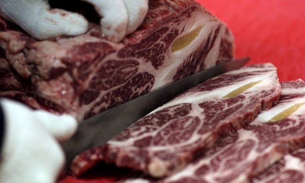  A man chops beef at a BBQ restaurant in Hongseong, South Korea, September 16, 2015 - REUTERS

