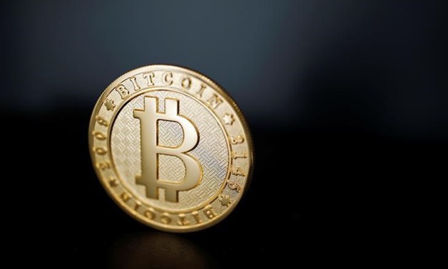 A Bitcoin (virtual currency) coin is seen in an illustration picture taken at La Maison du Bitcoin in Paris, France, June 23, 2017. REUTERS/Benoit Tessier/Illustration
