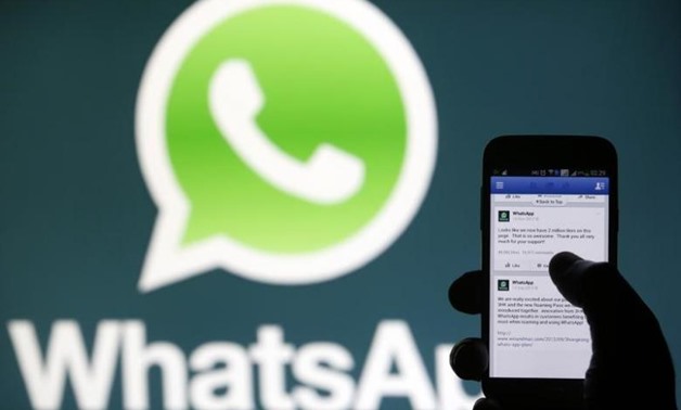 FILE PHOTO: A Whatsapp App logo is seen behind a Samsung Galaxy S4 phone that is logged on to Facebook in the central Bosnian town of Zenica, February 20, 2014. REUTERS/Dado Ruvic
