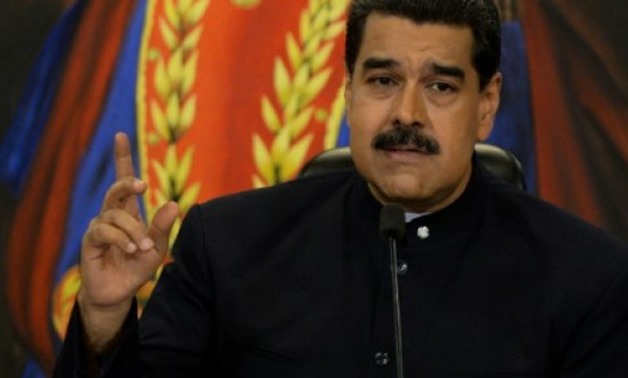© AFP/File / by Esteban ROJAS | Venezuelan President Nicolas Maduro is demanding the opposing Democratic Union Roundtable (MUD) coalition work for the lifting of US sanctions
