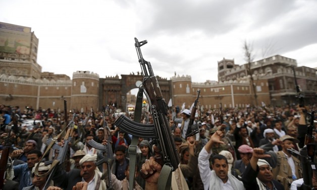 Shi’ite Muslim rebels hold up their weapons during a rally against air strikes in Sanaa March 26, 2015. REUTERS/Khaled Abdulla