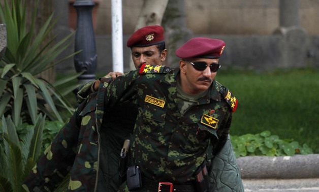 General Tariq Saleh, a nephew of former Yemeni leader Ali Abdullah Saleh, puts on his coat at the Republican Palace in Sanaa January 10, 2011. - Creative commons 
