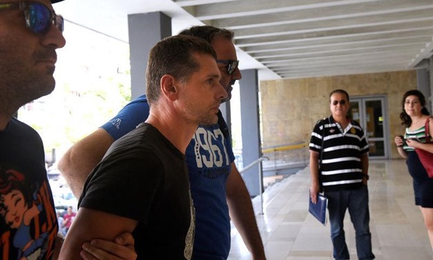 Alexander Vinnik, a 38 year old Russian man (2nd L) suspected of running a money laundering operation, is escorted by plain-clothes police officers to a court in Thessaloniki, Greece July 26, 2017 - REUTERS/Alexandros Avramidis