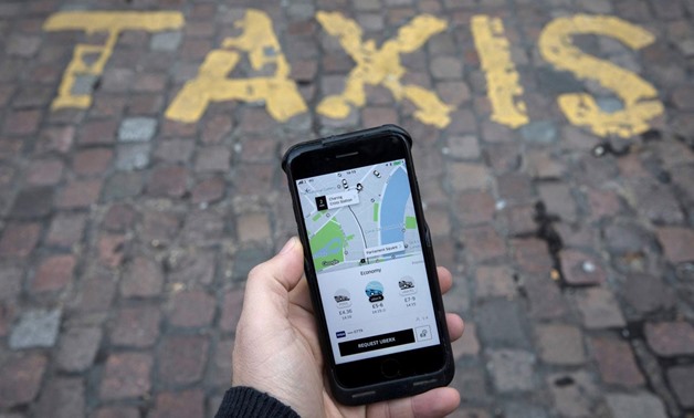 A photo illustration shows the Uber app on a mobile telephone, as it is held up for a posed photograph, in London, Britain November 10, 2017. REUTERS/Simon Dawson/File Photo
