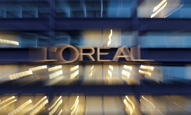 The logo of French cosmetics group L'Oreal is seen on the company's building in Clichy, near Paris February 12, 2015. Picture taken with zooming effect. REUTERS/Christian Hartmann