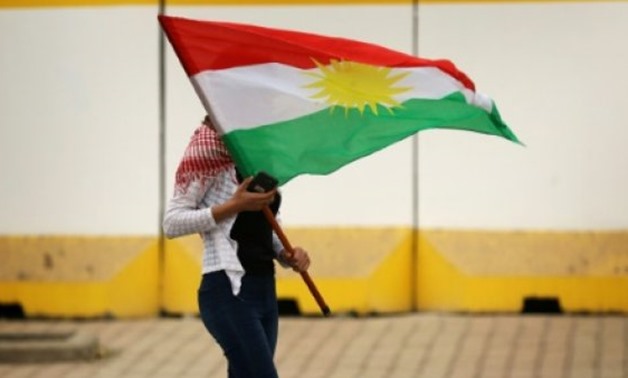 © AFP/File | A women attends a protest in support of the Iraqi Kurdish leader, in Arbil, the capital of autonomous Iraqi Kurdistan, in October 2017
