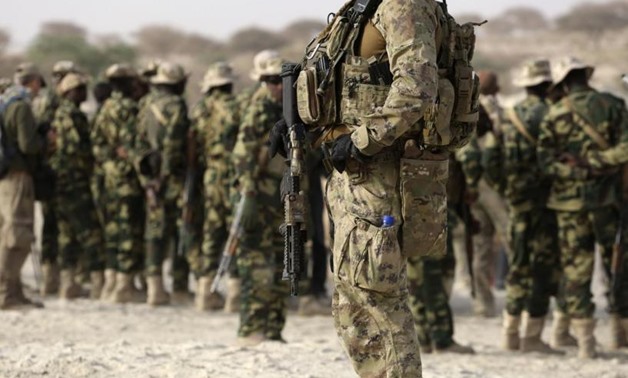 A U.S. special forces soldier stands in front of Chadian soldiers during Flintlock 2015, an American-led military exercise, in Mao, February 22, 2015. REUTERS/Emmanuel Braun