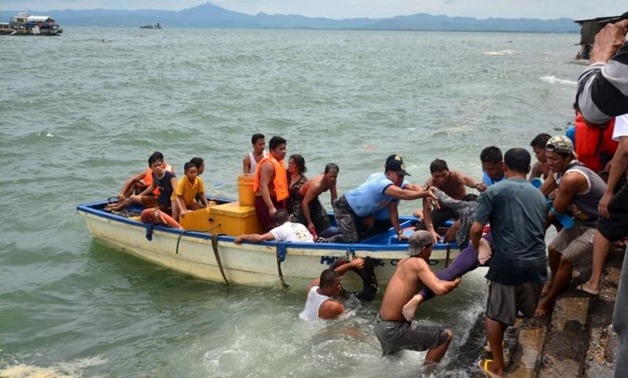 A body is carried by rescuers during a search and rescue operation following a ferry capsize in Ormoc city, central Philippines July 2, 2015. The ferry carrying 189 passengers and crew capsized off the central Philippines in heavy waves on Thursday, killi