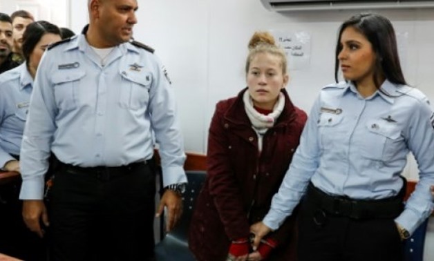 © AFP | Ahed Tamimi (2nd-R), a 17-year-old Palestinian campaigner against Israel's occupation, as well as her cousin Nour Naji and mother Nariman (UNSEEN) are to remain in custody until Thursday
