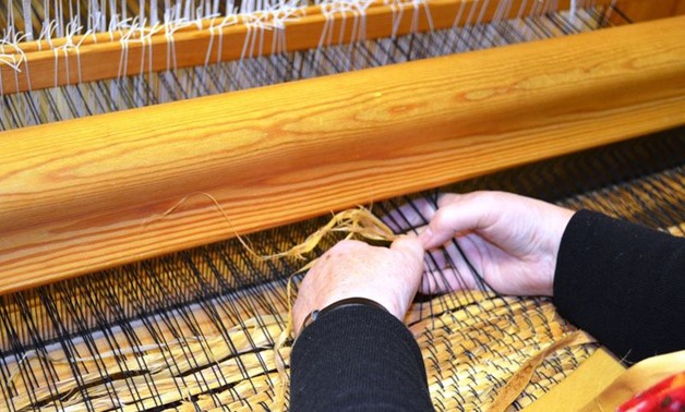 A woman weaving bast fibres from linden trees – Wikimedia Commons  