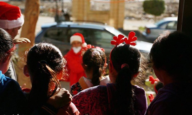 Hani Sheta, a real life Santa Claus giving gifts to poor Children - photo via Hani A-rahman Shetaea's Facebook page