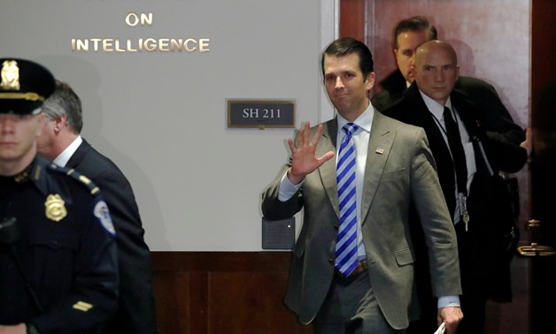 Donald Trump Jr., the president's son, waves at reporters as he departs after a full day being interviewed by Senate Intelligence Committee staff, as part of the panel’s ongoing investigation of allegations of Russia’s interference in the 2016 U.S. presid
