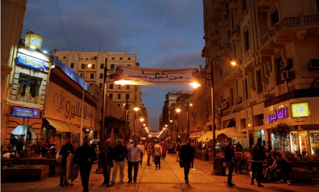 Egyptians walk in a street under a poster of President Abdel Fattah al-Sisi displayed for the campaign “Together for the best of Egypt" that calls for al-Sisi to run in the next year's presidential election in the capital of Cairo, Egypt December 24, 2017