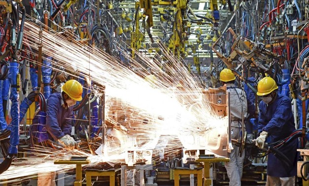 An employee works inside a metal workshop. REUTERS