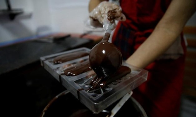 Adriana Pino makes chocolate bars at the +58 Cacao chocolate factory in Caracas, Venezuela October 6, 2017. REUTERS/Carlos Garcia Rawlins
