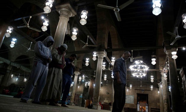 People take part in the night prayers inside an old mosque in Cairo, Egypt December 24, 2017. REUTERS/Amr Abdallah Dalsh