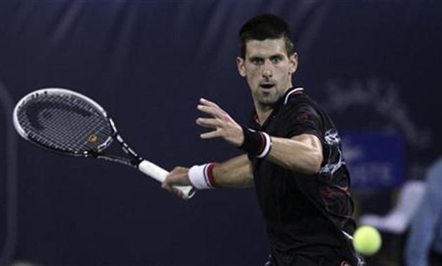 Novak Djokovic of Serbia hits a return to Cedrik-Marcel Stebe of Germany during their men's singles match at the Dubai Tennis Championships February 27, 2012. REUTERS/Mohammed Salem

