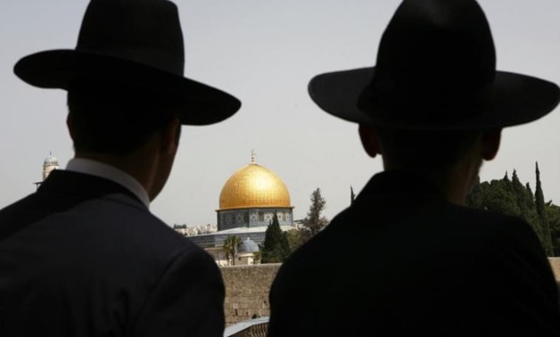 Ultra-Orthodox Jews look towards the Dome of the Rock in Jerusalem's Old City. (Photo credit: REUTERS)