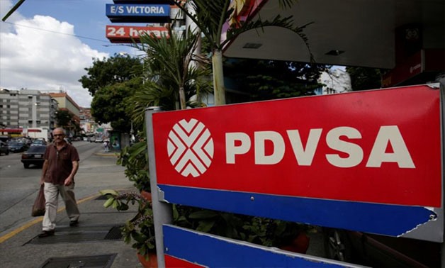 A man walks past the corporate logo of the state oil company PDVSA at a gas station in Caracas, Venezuela December 1, 2017 - REUTERS/Marco Bello/File Photo