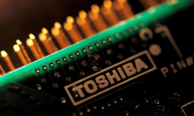 FILE PHOTO: A logo of Toshiba Corp is seen on a printed circuit board in this photo illustration taken in Tokyo July 31, 2012. REUTERS/Yuriko Nakao/File Photo