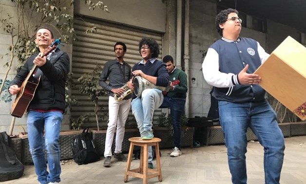 The organizers of “Mazzika Fel Share'a” event playing music in street - Photo by Mira Maged.
