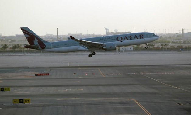 FILE PHOTO: A Qatar Airways plane is seen at Hamad International Airport in Doha, Qatar June 12, 2017. REUTERS/Naseem Zeitoon