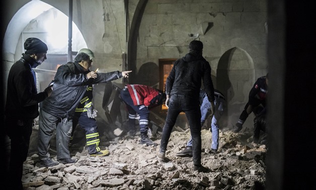 People clear rubble inside a mosque after it was hit by a rocket fired from Syria, in the border town of Kilis, Turkey January 24, 2018. Can Erok/Dogan News Agency via REUTERS