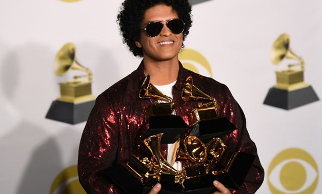 Singer Bruno Mars poses with his Grammy trophies during the 60th Annual Grammy Awards