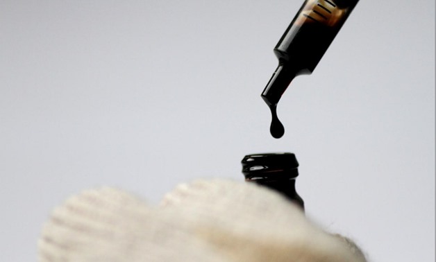 FILE PHOTO: Crude oil is dispensed into a bottle in this illustration photo June 1, 2017. REUTERS/Thomas White/Illustration/File Photo
