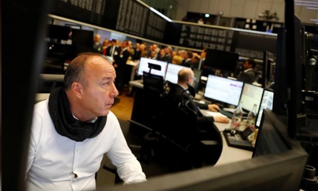 FILE PHOTO: A share trader checks his screens at the stock exchangee in Frankfurt, Germany, November 20, 2017. REUTERS/Kai Pfaffenbach
