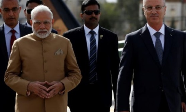 Indian Prime Minister Narendra Modi walks alongside Palestinian prime minister Rami Hamdallah in Ramallah on February 10, 2018