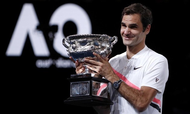 Tennis - Australian Open - Men's singles final - Rod Laver Arena, Melbourne, Australia, January 28, 2018. Switzerland's Roger Federer celebrates with the trophy as he poses after winning the final against Croatia's Marin Cilic. REUTERS/Edgar Su
