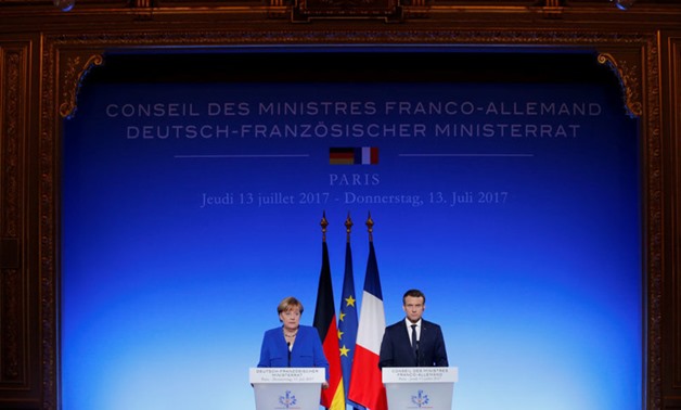 French President Emmanuel Macron and German Chancellor Angela Merkel attend a news conference following a Franco-German joint cabinet meeting at the Elysee Palace in Paris, France, July 13, 2017. REUTERS/Stephane Mahe Reuters