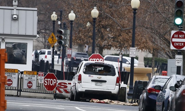 A passenger vehicle that struck a security barrier sits near the White House in Washington - Reuters
