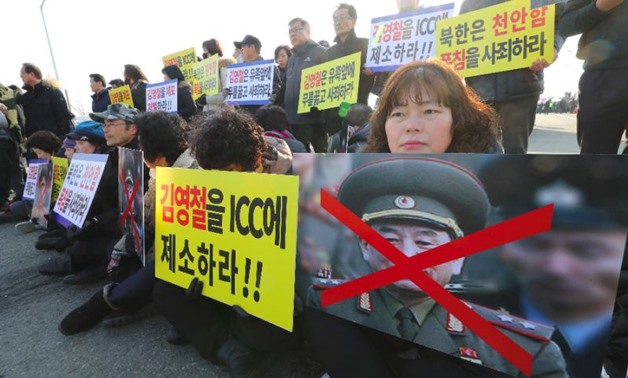 South Korean protesters hold placards showing a picture of North Korean general Kim Yong Chol - AFP
