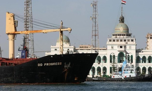 A cargo ship navigates past the Suez Canal Authority Building in Port Said, 180 kilometers northeast of Cairo, on November 24, 2008. (AFP)